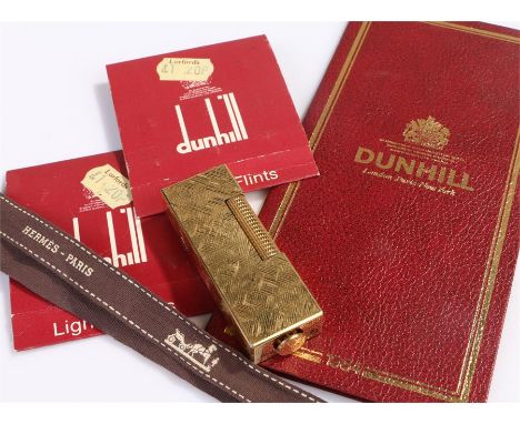 Dunhill lighter, gold plated with engine turned case, together with a diary and lighter fliters