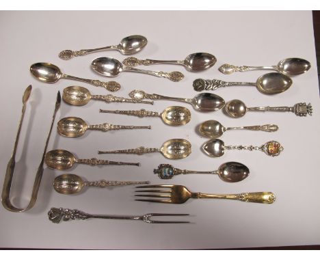 A Pair of Part Hallmarked Silver Sugar Tongs, two sets of decorative teaspoons, souvenir teaspoons, pickle fork stamped "800"