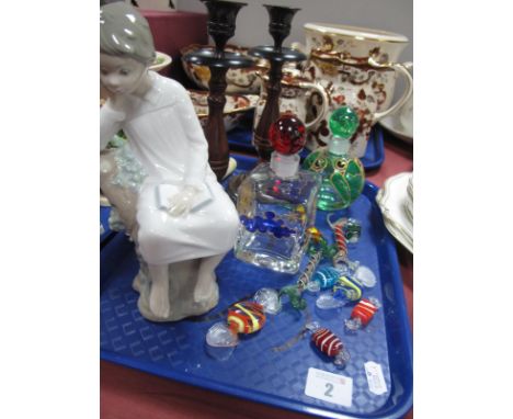 A Lladro Figure, of a boy sitting on tree trunk holding a book, Murano sweets, scent bottles, pair of candlesticks, etc:- One