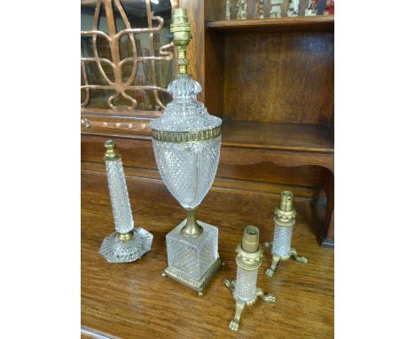 A selection of Art Deco cut glass table lamps to include a matching pair and a large trophy shaped lamp on glass cube plinth 