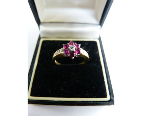 9ct Yellow Gold Ruby and Diamond cluster ring. Centre diamond approx 0.05ct surrounded by 6 similar size beautiful rubies wit