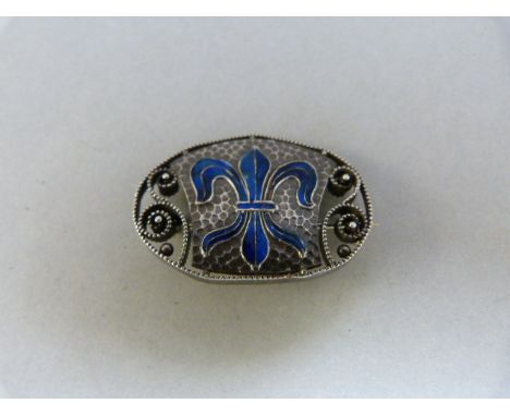 Oval enamel Murle Bennett brooch (early mark about 1910) with enamel 'Fleur-de-Lyre' in blue enamel. Approx 31mm x 21.8mm 
