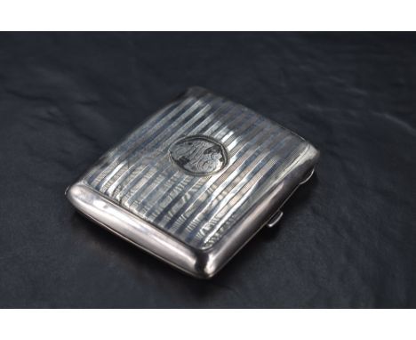A George V silver cigarette case, of hinged rectangular form curved for the gentleman's pocket and with bands of engine-turne