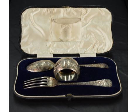 A cased Victorian silver christening set, comprising a napkin ring, fork and spoon, each with foliate engraved decoration, ma