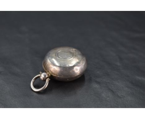 A Victorian silver sovereign holder, of typical hinged circular form with engine-turned decoration and circular cartouche, ma