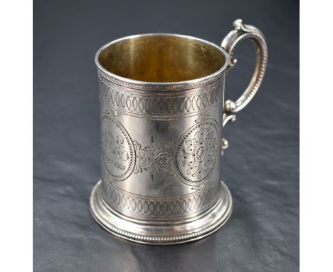 A Victorian silver christening mug, of cylindrical form with scrolled loop handle and bands of engine-turned decoration with 