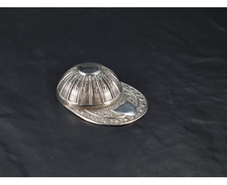 A Queen Elizabeth II silver caddy spoon, in the form of a Jockey's cap with embossed decoration  and vacant shield form carto