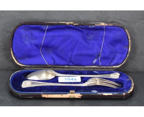 A cased Victorian silver christening set, comprising bead and shell pattern fork and spoon, marks for London 1876, maker Atki