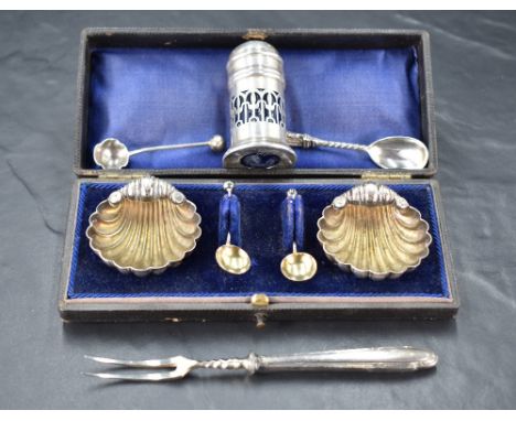 A pair of late Victorian silver salts, of scallop shell form with three ball feet and simple spoons, all housed in a fitted p