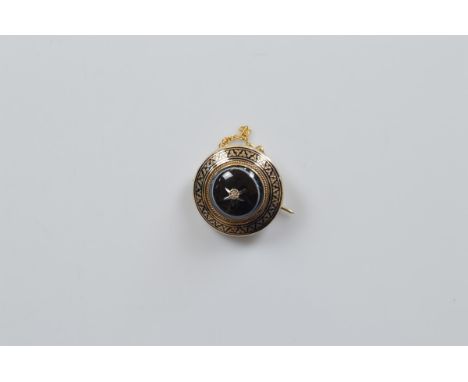 A Victorian onyx and diamond gold and enamel mourning brooch, of circular target design centred with bullseye onyx with illus