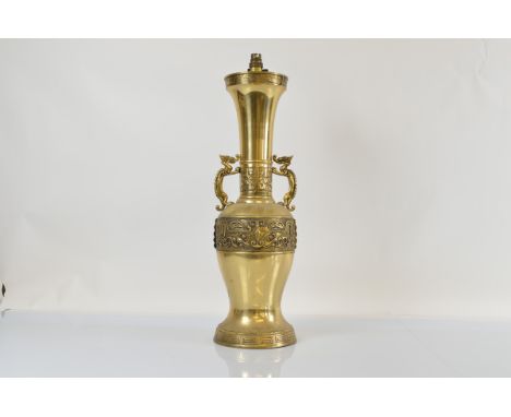 A large Chinese brass dragon twin handled lamp base, of tapered design with Greek key decoration and Chinese motifs, 65cm max