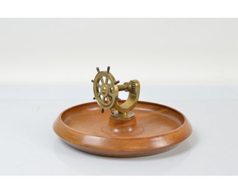 A treen nautical themed nut bowl and cracker, the turned wooden teak bowl surmounted with a ships wheel screw and base, 28cm 
