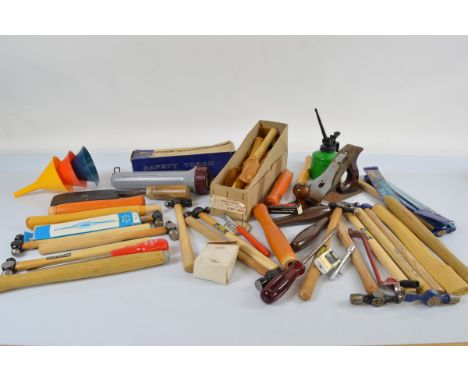 A quantity of workshop tools, including engineer hammers, wood planes, and other items