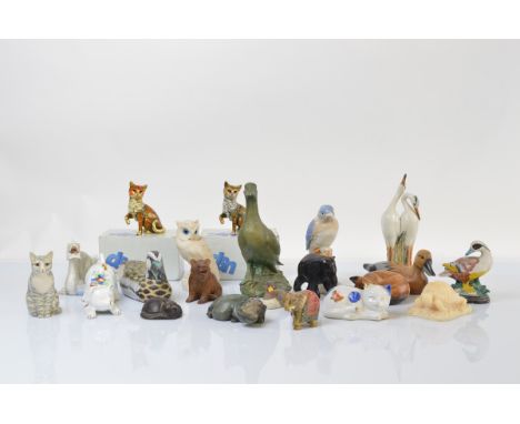 A collection of animal figurines, including two Black Forest examples of bears, various pottery and porcelain figures of cats
