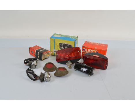 A small collection of car lights, including two chromed Lucas wing mounts, reflectors, a Lucas number plate lamp in box and t