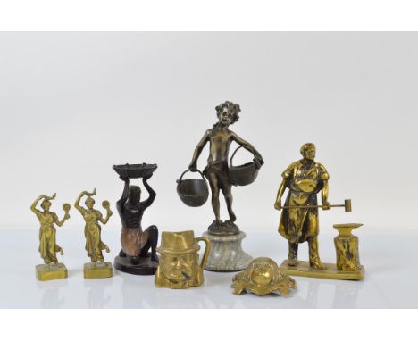 A collection of figural metalware, including a brass model of a gentleman blacksmith, 21cm high, a bronzed centre piece of Eg