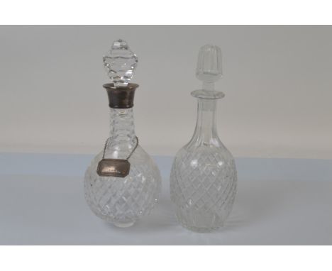 A contemporary silver collared cut glass decanter, of spherical form with small circular foot, stopper and silver label, 32 c