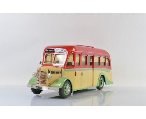 A painted wooden model of a Bedford Coach, in Whittaker's Tours West Midlands livery, with photographs and Test certificates 