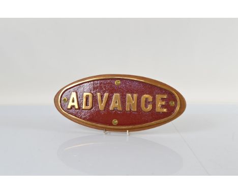 A brass and enamel oval lorry plate, mounted on mahogany stand, 'Advance' 40cm x 17cm