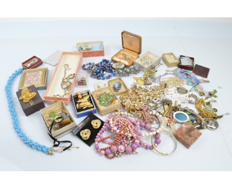 A collection of costume jewels, including a tiger's eye pendant, Scottish brooch and matching earrings, silver charm, various