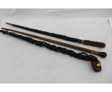 First World War Propeller walking stick, another walking stick carved in the form of an umbrella, and another with coiled bra