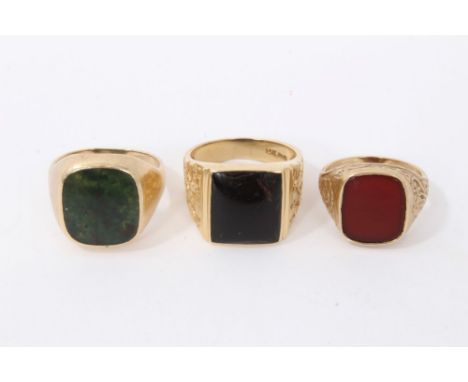 Three gold signet seal rings to include 14k gold with black onyx panel, size T, 9ct gold with bloodstone panel, size T½ and o