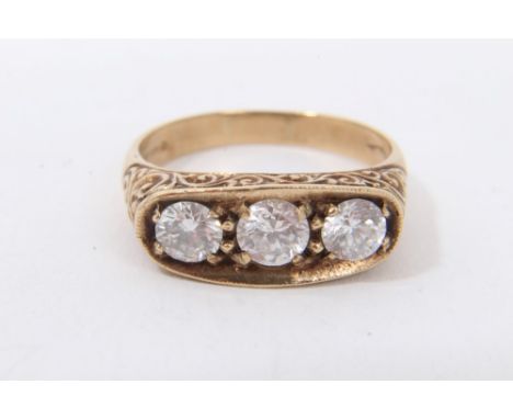 Gold 9ct three stone ring with three white synthetic stones in engraved scroll setting, ring size V½Condition report: Weight 