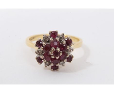 18ct gold ruby and diamond cluster ring with a flower head cluster in tiered claw setting on 18ct gold shank. Finger size P.C