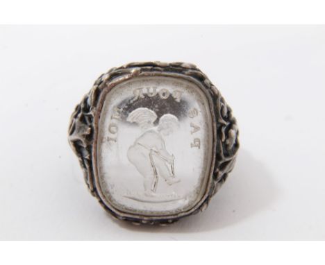 19th Century intaglio depicting a cherub “Pas Pour Moi”, in foliate design white metal ring mount, size K
