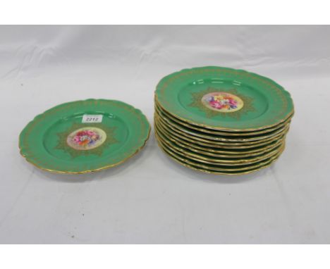 Twelve Royal Worcester cabinet plates with central hand painted floral decoration signed S. Stanley with green and gilt borde