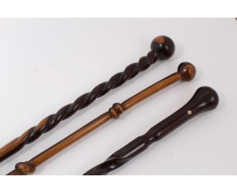 Exotic wood walking stick with carved knot decoration and rondel handle, together with two others with carved twisted decorat