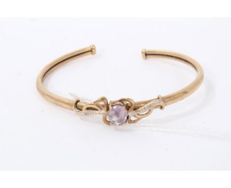 Gold 9ct amethyst torque bangle with a central single oval cut amethyst flanked by an illusion set diamond to each shoulderCo