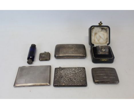 Four silver cigarette cases, silver vesta case, silver napkin ring in fitted case and silver-mounted blue glass double ended 