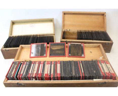 Two boxes of glass negative slides, mostly Victorian/Edwardian costumes, together with a box of magic lantern slides, with to