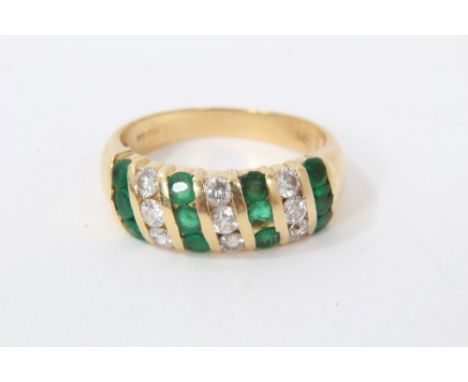 18ct gold emerald and diamond ring with triple rows of emeralds and diamonds in 18ct channel setting. London 1989. Finger siz