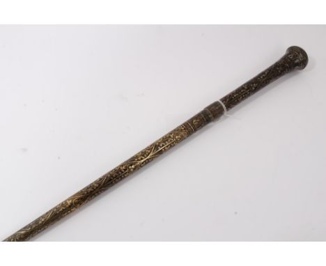 Early 20th century heavy metal walking stick with raised Nielloware style decoration and wriggle work ferrule, 90.5cm overall