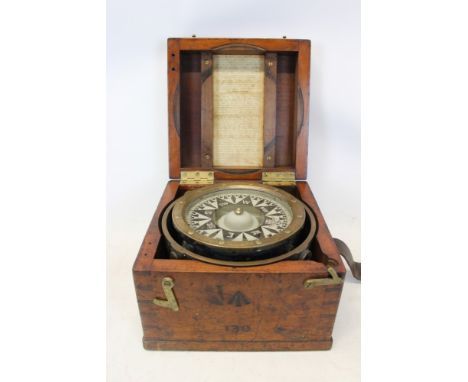 A Military 'Dent's Improved Liquid Azimuth Compass', in brass gimbal setting, in a mahogany case with leather strap, the fron
