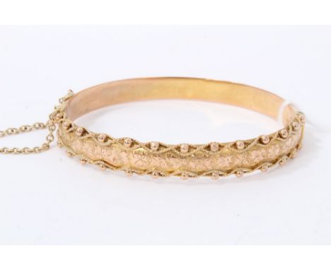 Gold 9ct bangle with engraved foliage design, ball and rope twist decorationCondition report: Weight approximately 9.7g