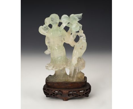 Figure of fairy with bird. China, 20th century.Jade carved by hand on wooden base.Measurements: 13 cm (height figure); 4 cm (