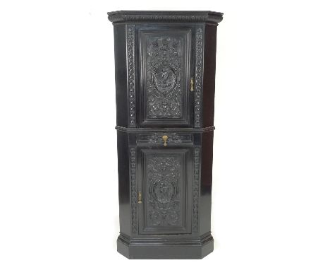 An early 20th century ebonised corner cupboard, in the manner of Collinson & Lock, of freestanding form with two cupboards an
