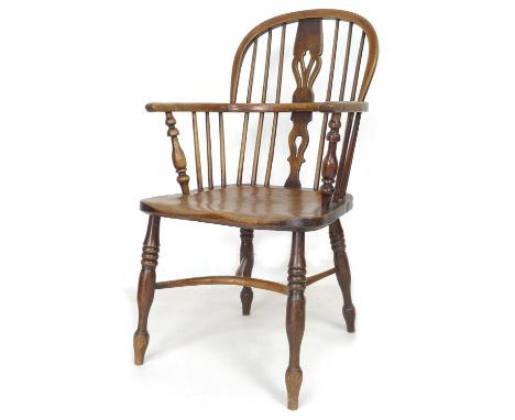 A 19th century oak and elm Windsor chair, low rounded back with pierced splat and stick supports, crinoline stretcher, turned