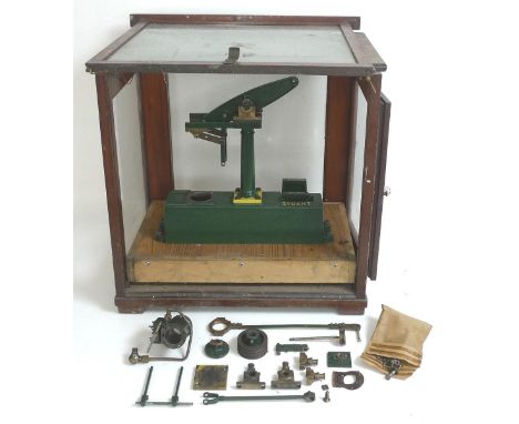 A vintage cast metal model of a beam engine, by Stuart, partly assembled and likely incomplete, painted green with yellow log