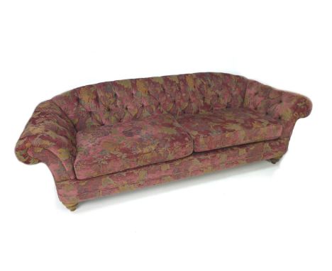 A Victorian style Chesterfield sofa, newly re-upholstered in burgundy floral fabric, 240 by 90 by 79cm high. 