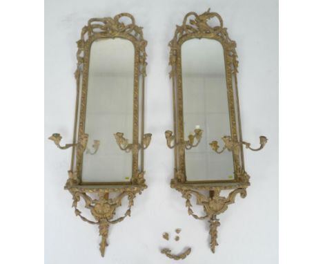 A pair of 19th century and later gilt framed girandole mirrors, with moulded fruit and leaf frames around arched rectangular 