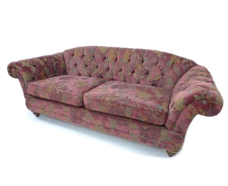 A Victorian style Chesterfield sofa, newly re-upholstered in burgundy floral fabric, 210 by 90 by 82cm high. 