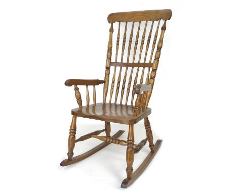 A Victorian elm stick back rocking chair, with turned H stretcher, 56 by 70 by 107cm high. 