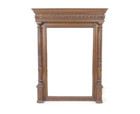 An Edwardian overmantel mirror, with bevelled rectangular plate, architectural oak frame with turned and fluted columns suppo