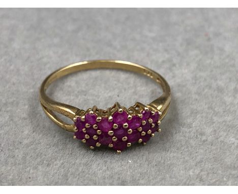 A HALLMARKED 9ct GOLD RUBY MULTI CLUSTER DRESS RING. FINGER SIZE T. WEIGHT 1.5grms.