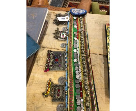 AN EASTERN WHITE METAL MOUNTED AND BEADED SASH BELT. 