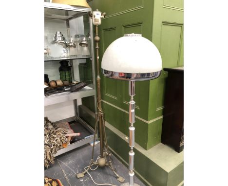 A BRASS TRIPOD STANDARD LAMP AND A CHROME STANDARD LAMP WITH DOMED MILK GLASS SHADE.